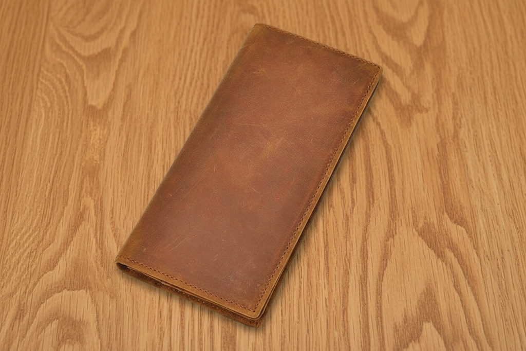 Brown leather wallet on a wooden surface