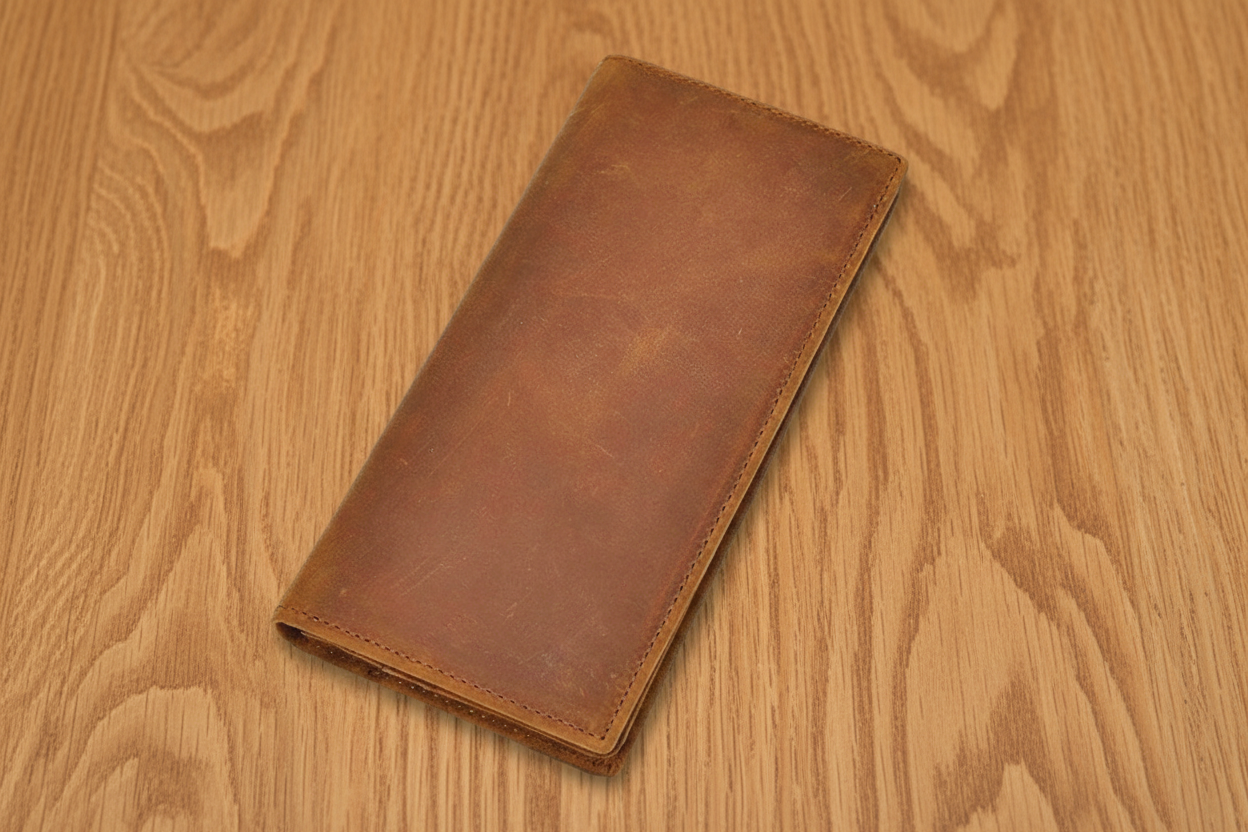 Brown leather wallet on a wooden surface