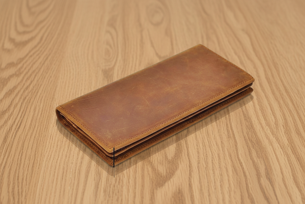 Brown leather wallet on a wooden surface