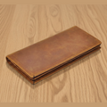 Brown leather wallet on a wooden surface