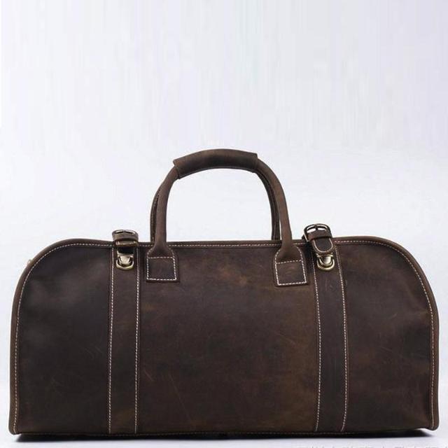 Dark brown leather travel bag with minimalist design and white stitching, Stein & Birke