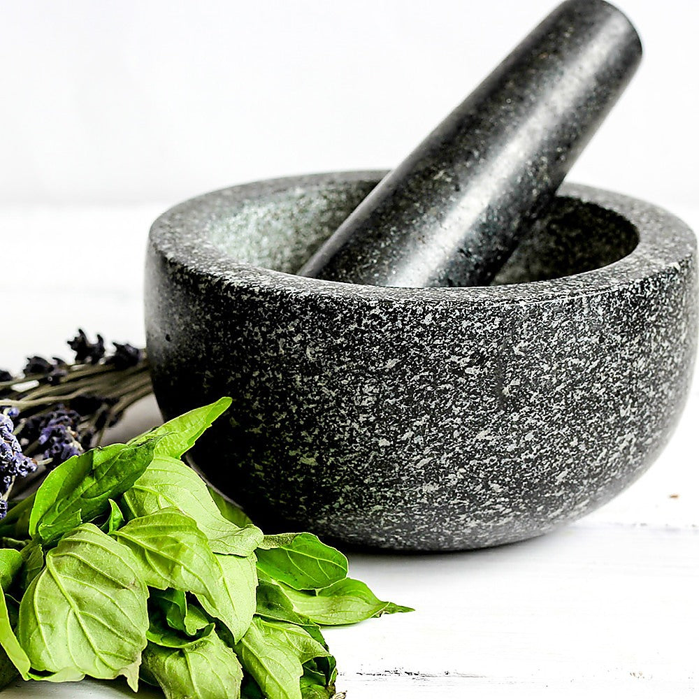 Granite mortar and pestle with fresh basil and lavender, Alpine-Nordic minimalist kitchenware