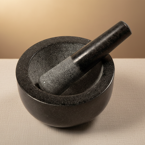 Black stone mortar and pestle on a white background