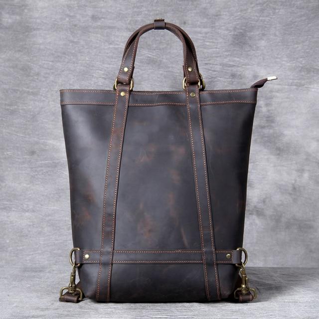 Brown leather tote bag on a gray background